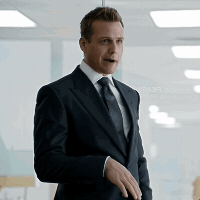 Man In Suit Standing In Front Of Glass Wall Saying A2b3r GIF