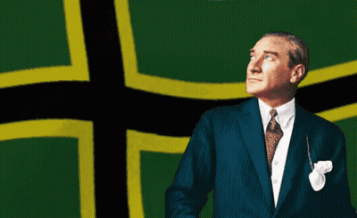 Man In Suit Standing In Front Of Green And Yellow Cross GIF
