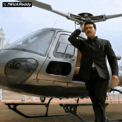 Man in Suit Standing in Front of Helicopter With 7wick Reddy