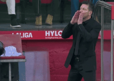 Man In Suit Standing In Front Of Hylo Sign GIF