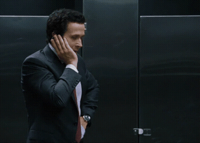 Man In Suit Standing In Front Of I'm Jacked To The Sign GIF