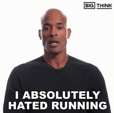 Man In Suit Standing In Front Of Jalen Milroe Football Screen GIF