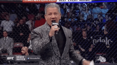 Man In Suit Standing In Front Of Microphone GIF