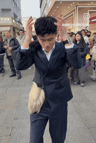 Man In Suit Standing In Front Of Minkookhairstudio GIF