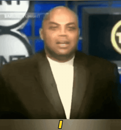Man In Suit Standing In Front Of NBC TV Screen GIF