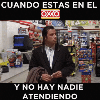 Man In Suit Standing In Front Of OXXO Sign GIF