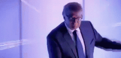 Man In Suit Standing In Front Of Projection Screen GIF