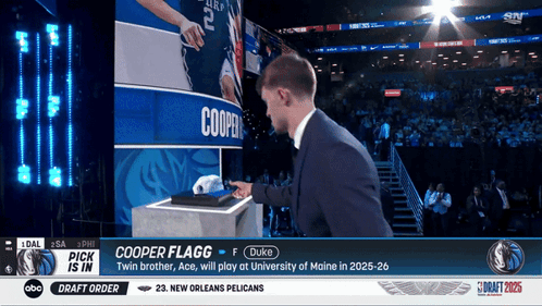 Man In Suit Standing In Front Of Screen With Name Cooper GIF