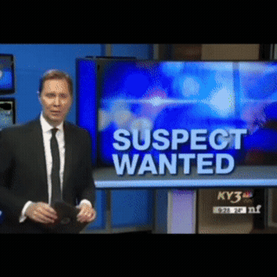Man In Suit Standing In Front Of TV Saying Suspect Wanted GIF
