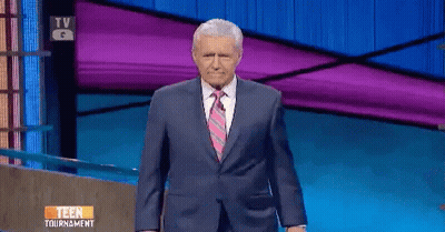 Man In Suit Standing In Front Of TV Saying Teen Tournament GIF