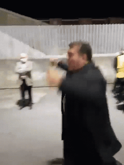 Man In Suit Standing In Front Of Wall GIF