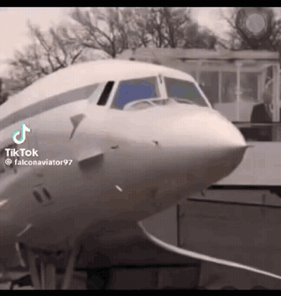 Man In Suit Standing In Front Of White Airplane GIF