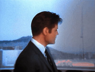 Man In Suit Standing In Front Of Window GIF