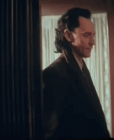 Man In Suit Standing In Front Of Window GIF
