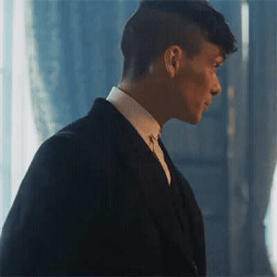 Man In Suit Standing In Front Of Window GIF