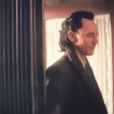 Man In Suit Standing In Front Of Window GIF