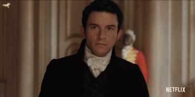 Man In Suit Standing In Hallway With Netflix Logo GIF
