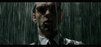 Man In Suit Standing In Rain With Sunglasses GIF