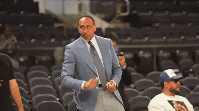 Man In Suit Standing In Stadium GIF
