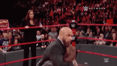 Man In Suit Standing In Wrestling Ring GIF