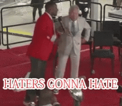 Man In Suit Standing Next To Another On Red Carpet Haters Gonna Hate GIF