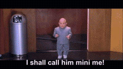 Man In Suit Standing Next To Metal Object GIF