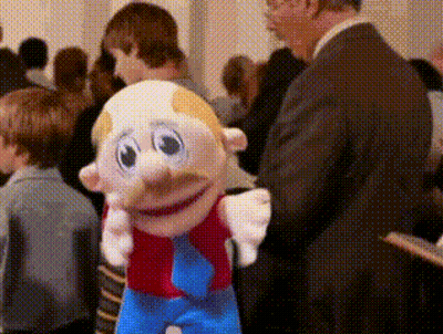 Man In Suit Standing Next To Mustache Toy GIF