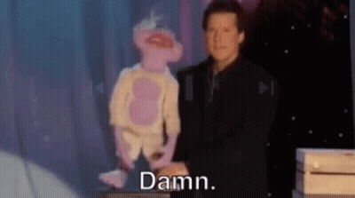 Man In Suit Standing Next To Pink Monkey Puppet GIF