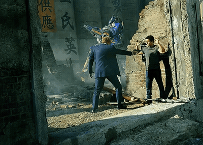 Man In Suit Standing Next To Robot With Chinese Writing GIF