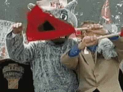 Man In Suit Standing Next To Shark Mascot GIF