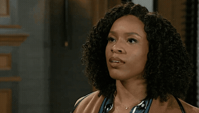 Man In Suit Standing Next To Woman In Brown Coat GIF