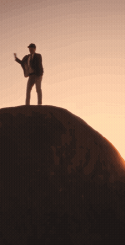 Man In Suit Standing On Hill GIF