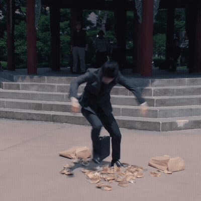 Man In Suit Standing On Pile Of Food GIF