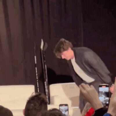 Man In Suit Standing On Stage GIF
