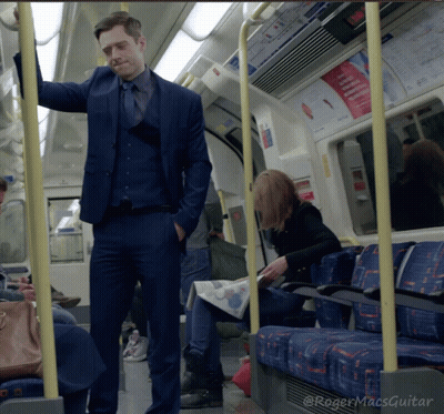 Man In Suit Standing On Train GIF