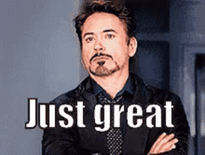 Man In Suit Standing With Arms Crossed Saying Just Great GIF