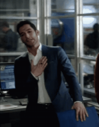 Man In Suit Standing With Hands On Chest GIF