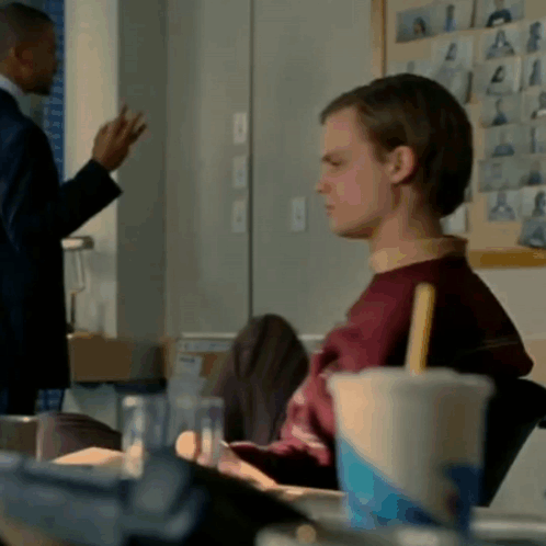 Man In Suit Stands Next To Man In Red Sweater GIF