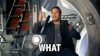 Man In Suit Surprised At Table GIF