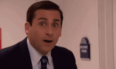 Man In Suit Surprised In Front Of Door GIF