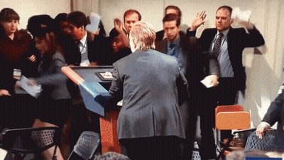Man In Suit Surrounded By Crowd GIF
