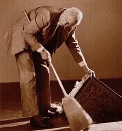 Man In Suit Sweeping Floor GIF