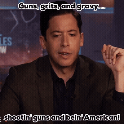 Man In Suit Talking About Guns Grits And Gravy GIF