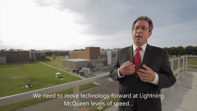 Man In Suit Talking About Lightning McQueen Speed GIF