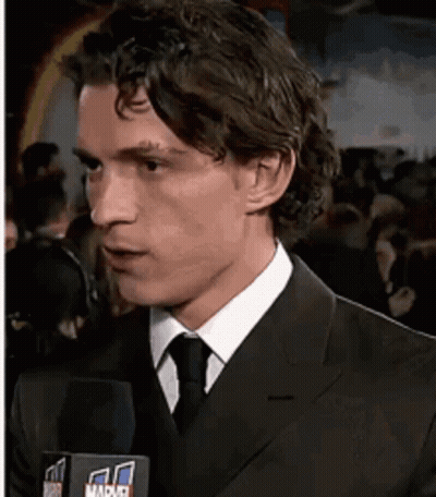 Man In Suit Talking Into Marvel Microphone GIF