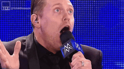 Man In Suit Talking Into Microphone GIF