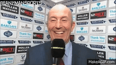 Man In Suit Talking Into Microphone In Front Of Barclays Logos GIF
