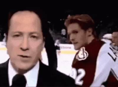 Man In Suit Talking Into Microphone GIF