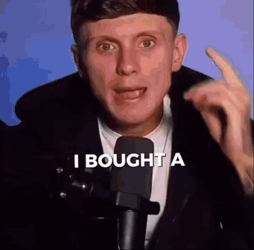 Man In Suit Talking Into Microphone Saying I Bought A GIF