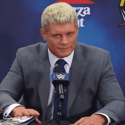 Man In Suit Talking Into Microphone With Pizza Hut Logo GIF